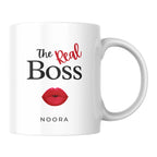 White mug with 'The Real Boss' text and red lips design on a white background